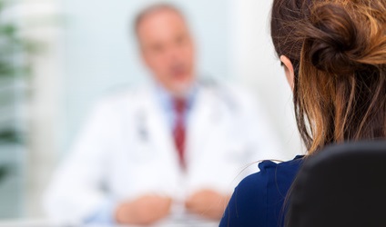 doctor talking to female patient